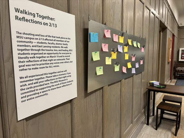 a photo of a sign on the wall that says Walking Together, Reflections on 2/13. Next to it is a sign of multi-colored sticky notes.