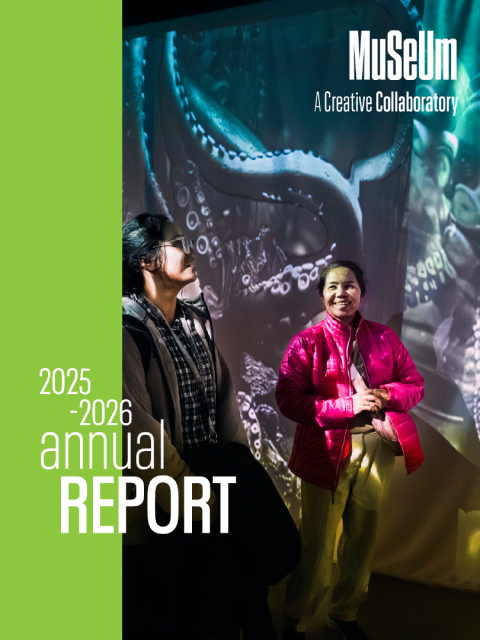 Block image Cover for the 2025-26 MSU Museum Annual Report, featuring a lime green stripe on the left with an image of MSU Museum visitors smile as they explore an installation with moving imagery and sound displaying scenes of Afrofuturism and the ocean on curtains around them on the right.